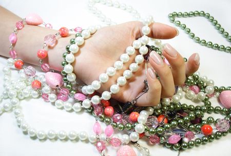 human hand is holding different beadsの写真素材