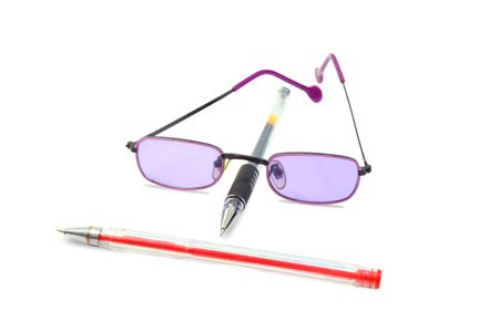 Isolated red and black pens and lilac glassesの写真素材