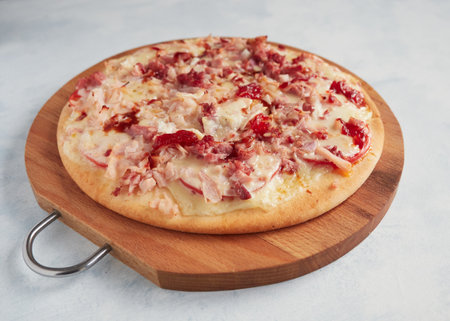 whole homemade pizza on a wooden board with blue backgroundの写真素材