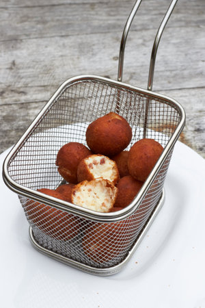 croquettes typical Spanish food tapas served in a metal basket on a white plateの写真素材