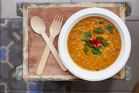 dal typical indian cuisine dish. view from above served on recyclable kitchenware, wooden cutleryの写真素材