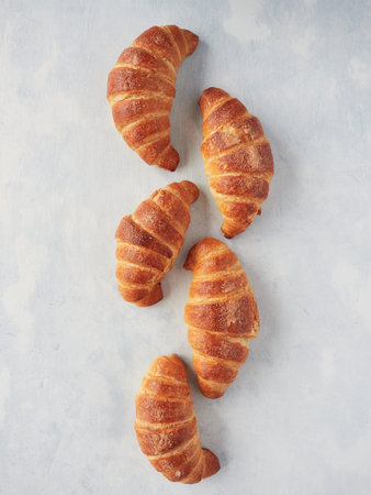 five rustic artisan french croissants horn shape in a flat lay modern composition