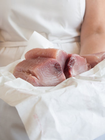 ready to sell frehs tuna loin in fishmonger handsの写真素材
