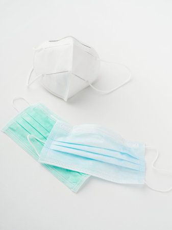 three different types of face masks on a white background vertical top view