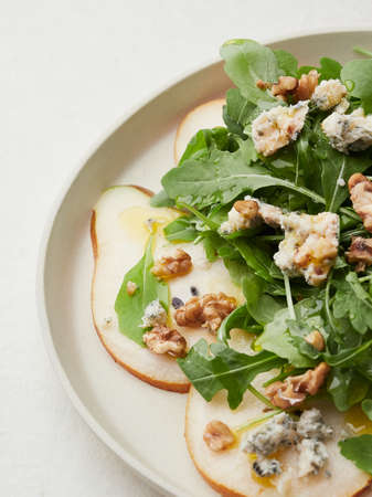 close-up view of rocket, pear, blue cheese and walnut saladの写真素材