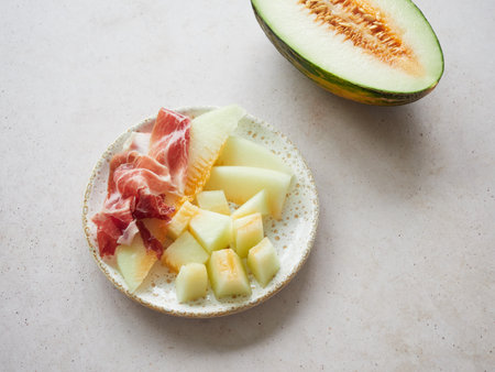 Typical spanish food, melon with ham on a plate. Contrast sweet salty flavor. Starter, appetizer and first course.の写真素材