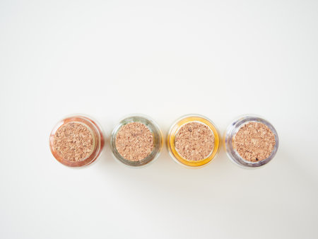 close-up top view of cork stoppers in colored glass vials isolated on a plain backgroundの写真素材