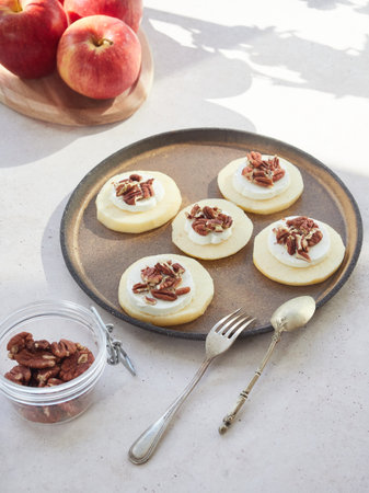 Dessert plate or healthy snack: apple slices, fresh cheese and pecans.の写真素材