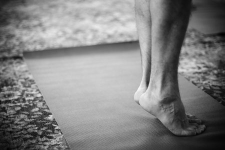 male foot doing yoga