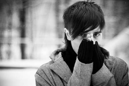 Man is warming his hands in winterの写真素材