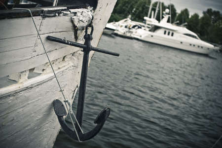 Hanging anchor on the wooden yachtの写真素材