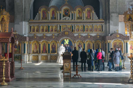 MOSCOW - MARCH 10: bride and groom and guests stand opposite the iconostasis during orthodox wedding ceremony on March 10, 2013 in Moscowのeditorial素材