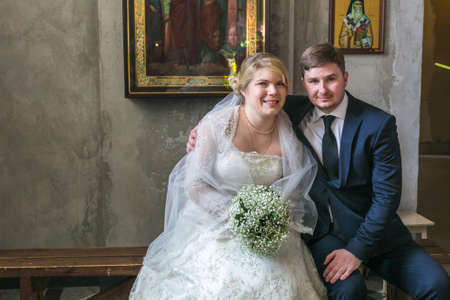 MOSCOW - MARCH 10: bride and groom sit during orthodox wedding ceremony on March 10, 2013 in Moscowのeditorial素材