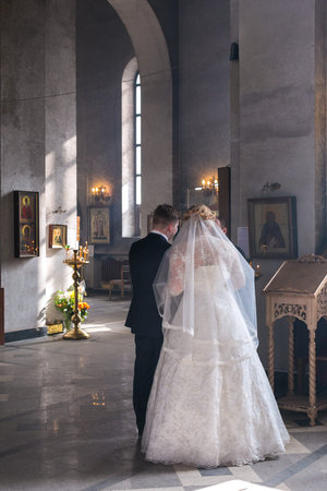 MOSCOW - MARCH 10: bride and groom speak to priest during orthodox wedding ceremony on March 10, 2013 in Moscowのeditorial素材