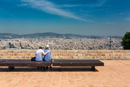 Beautiful city landscape in Barcelona and unidentified couple in summer timeの写真素材
