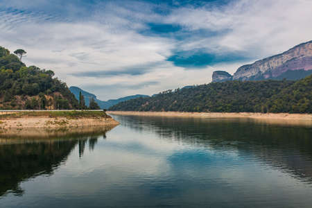 Beautiful nature landscape with dam building in vivid colors.の写真素材