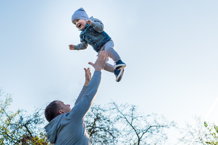 Dad throws his son up. concept father daysの写真素材