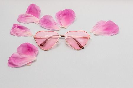 flat lay with glasses and flowers petalsの写真素材