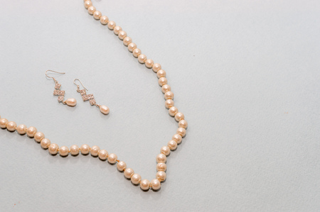 Beads and pearl earrings on a blue backgroundの写真素材