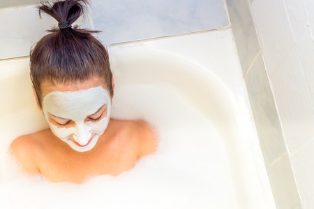 Young woman with mask on face with closed eyesの写真素材