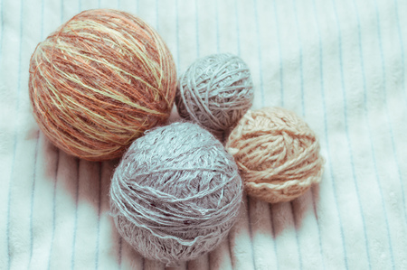 Four tangles of yarn on a white plaid. Toning.の写真素材