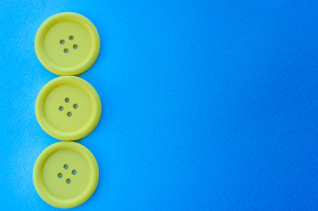 Three yellow buttons on a blue background.の写真素材