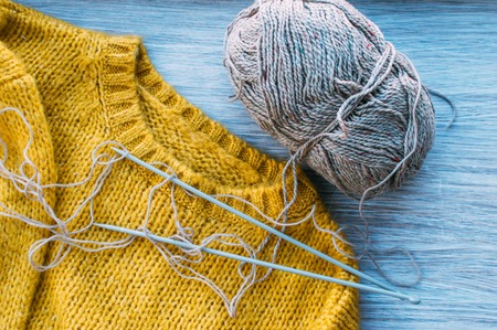 Knitted wool sweater and yarn. Concept knitting and winter.の写真素材