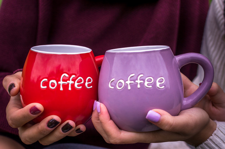 Two large cups in the hands close-up. Concept loveの写真素材