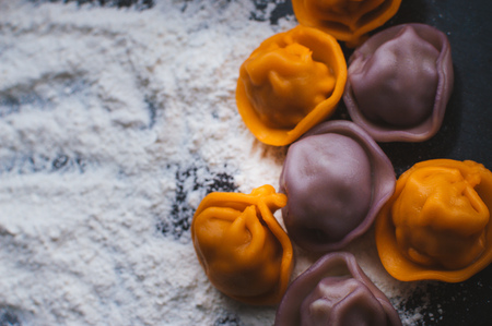 Multi-colored dumplings and white flour nearbyの写真素材