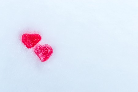 Two red hearts on snow .St. Valentine's Day. Concept love and romanticの写真素材