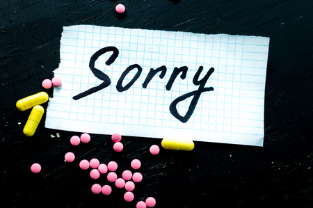 On a black background pills closeup. Suicide note. Suicideの写真素材