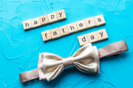 Man's tie and father's day inscription on blue background. Close upの写真素材