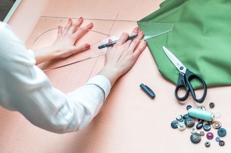 Hands of fashion designer close up designing clothesの写真素材