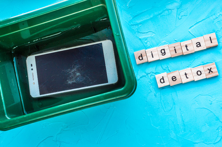 Concept digital detox. Smartphone in the waterの写真素材