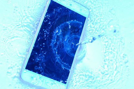 Phone in water close up. Concept broken phone. Copy spaceの写真素材