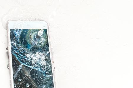 Mobile phone dropped into the water in the bathroomの写真素材