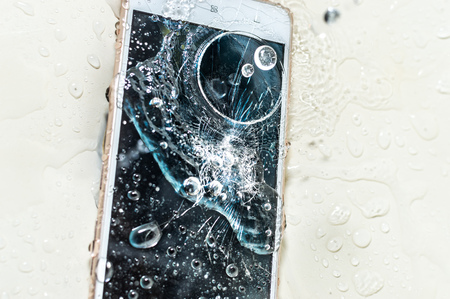 Phone in the water. Concept broken phone. Smartphone repair conceptの写真素材