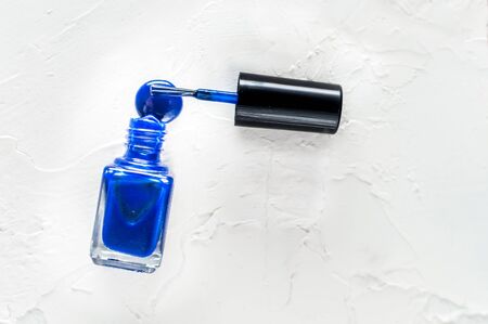 Bottle of blue nail polish on a white background. Classic Blue color 2020の写真素材