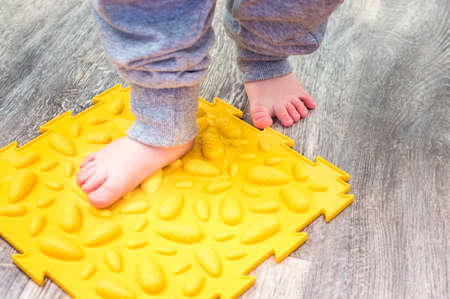 Child's feet on the orthopedic mat close-up. Valgus conceptの写真素材