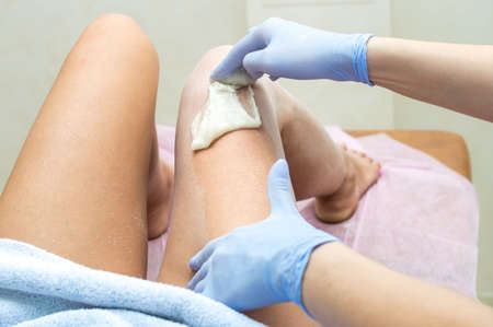 Hair removal leg with sugar paste in a beauty salonの写真素材