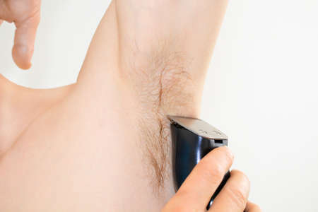 Underarm shaving with a trimmerの写真素材