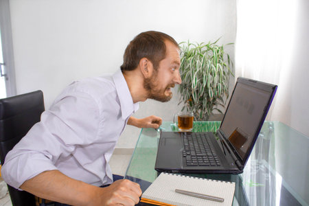 Angry man behind the desk at office