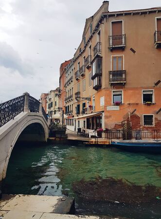 The bridge over venetian canal after the rain, ancient architecture of Italyの写真素材