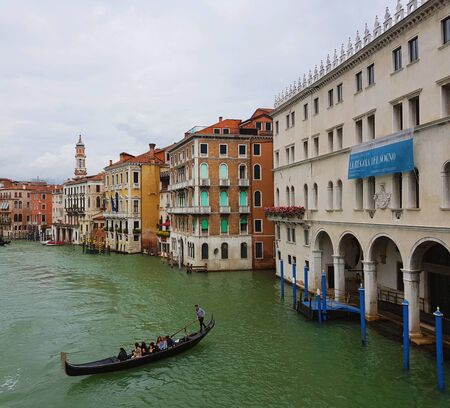 Venetian canal with gondola after the rain, ancient architecture of Italyの写真素材