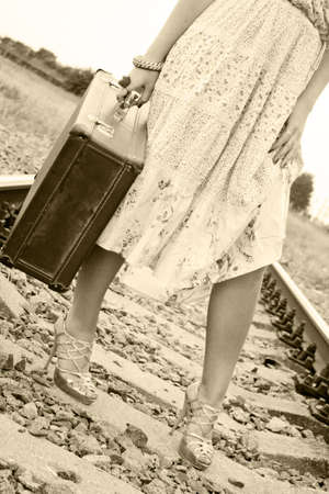 The girl on rails with a suitcaseの写真素材