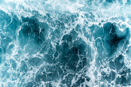 The ocean shows strong waves moving quickly. The sun shines brightly on the water. This scene takes...