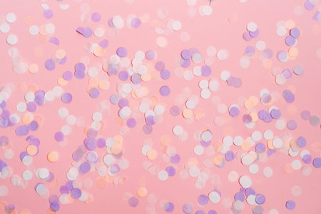 Pink pastel festive background with colorful confetti. Flat lay style.