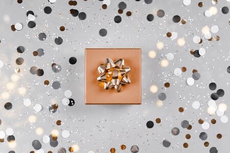 Present box on silver sparkling background.の写真素材