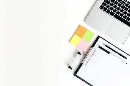 Coaching business tools like hourglass, notebok, pens and tablet on a white wooden background. Flat...