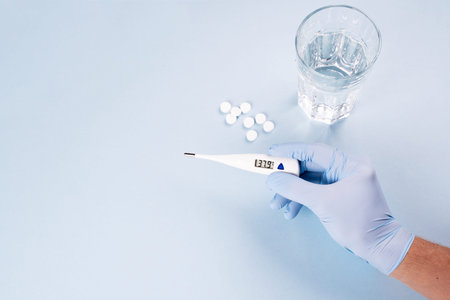 Electronic thermometer for measuring temperature in the hands of the doctor.